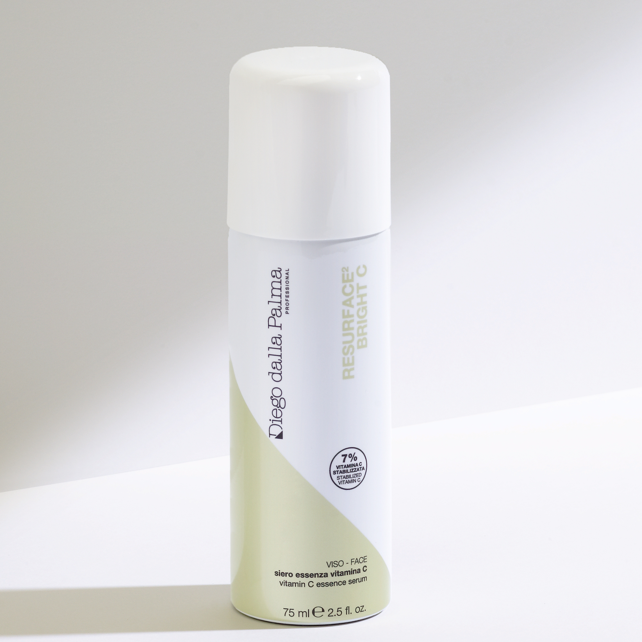 Skincare bottle with white cap and green body on a light gray background