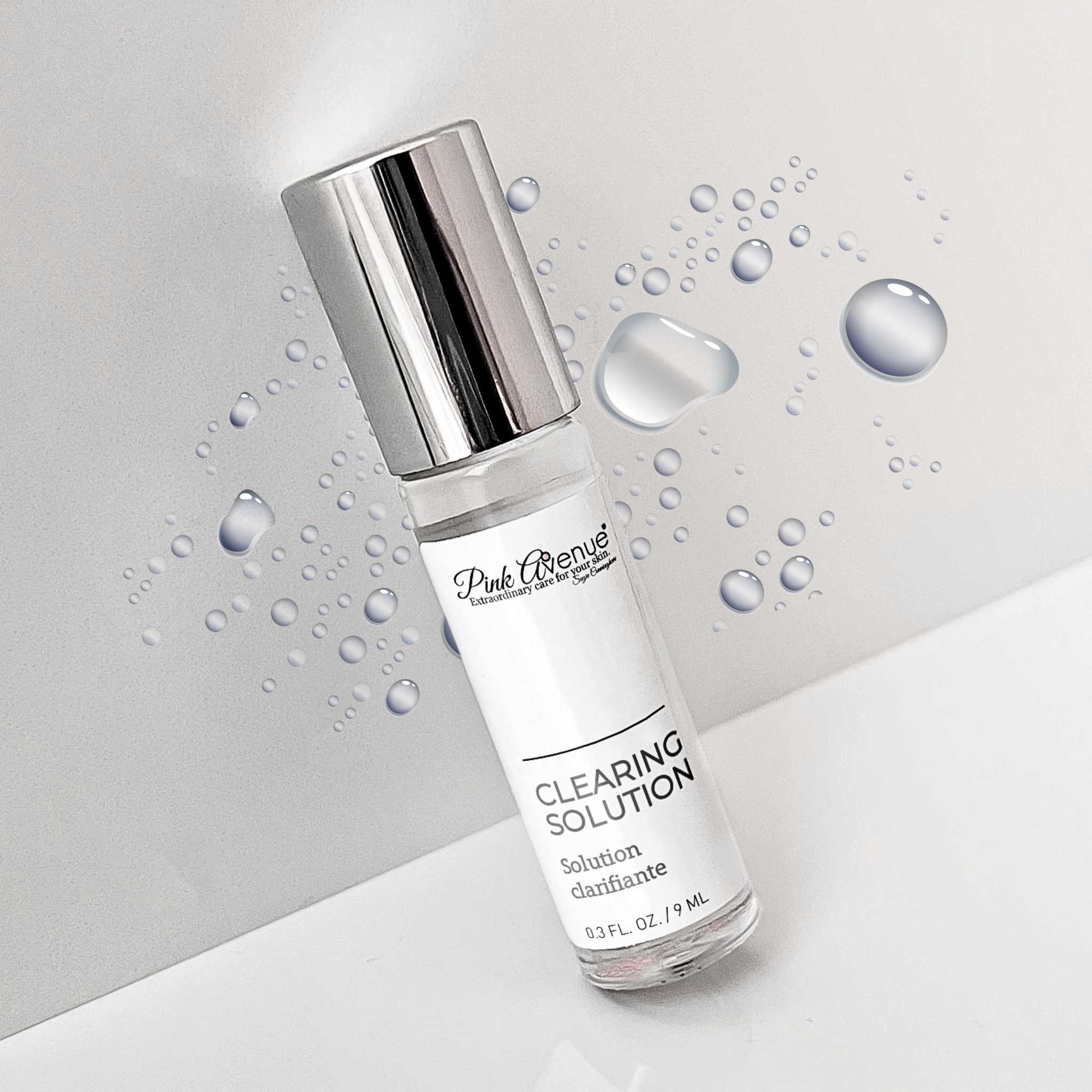 Bottle of 'Clearing Solution' with water droplets on a light gray background
