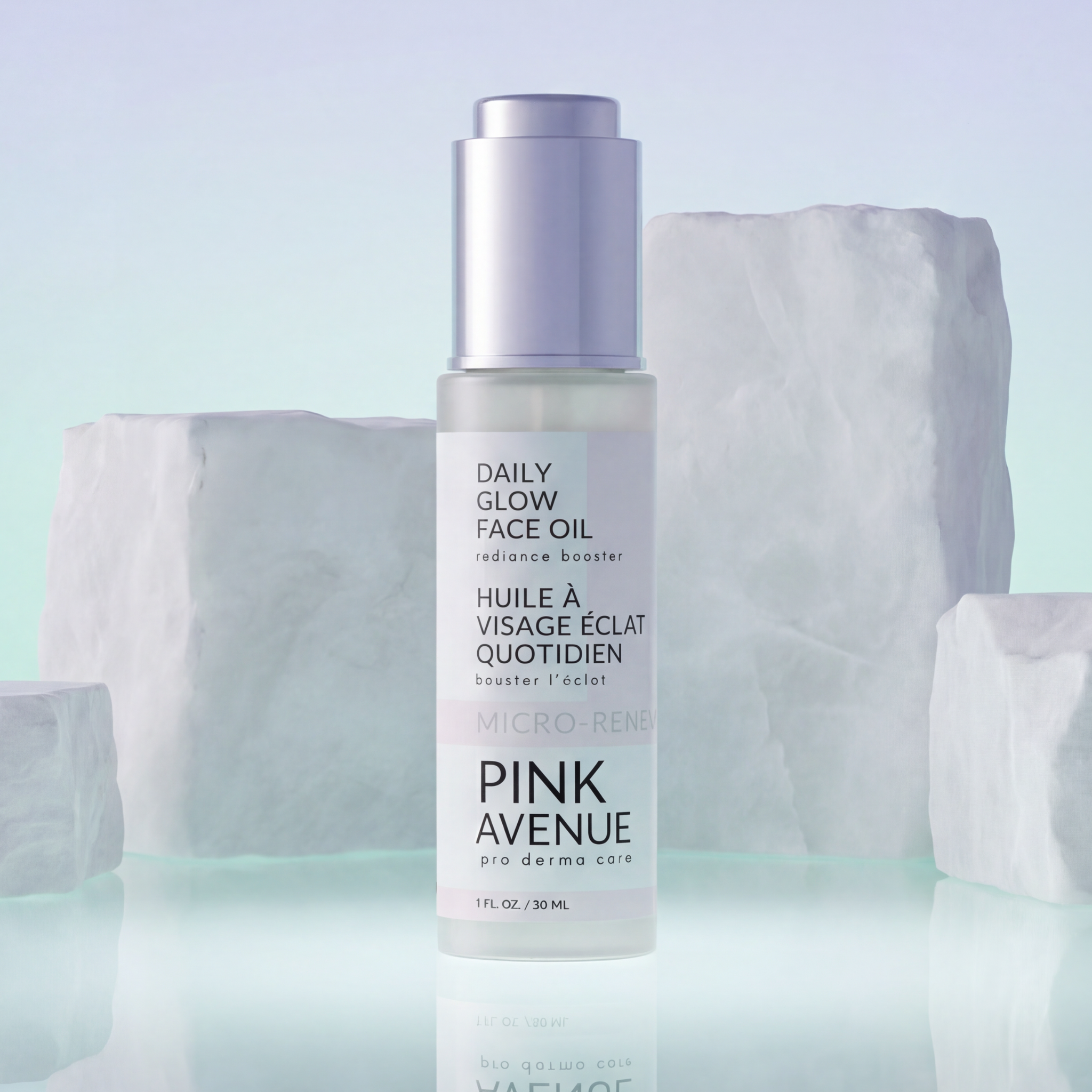 Pink Avenue Daily Glow Face Oil bottle on a light blue background with marble-like texture