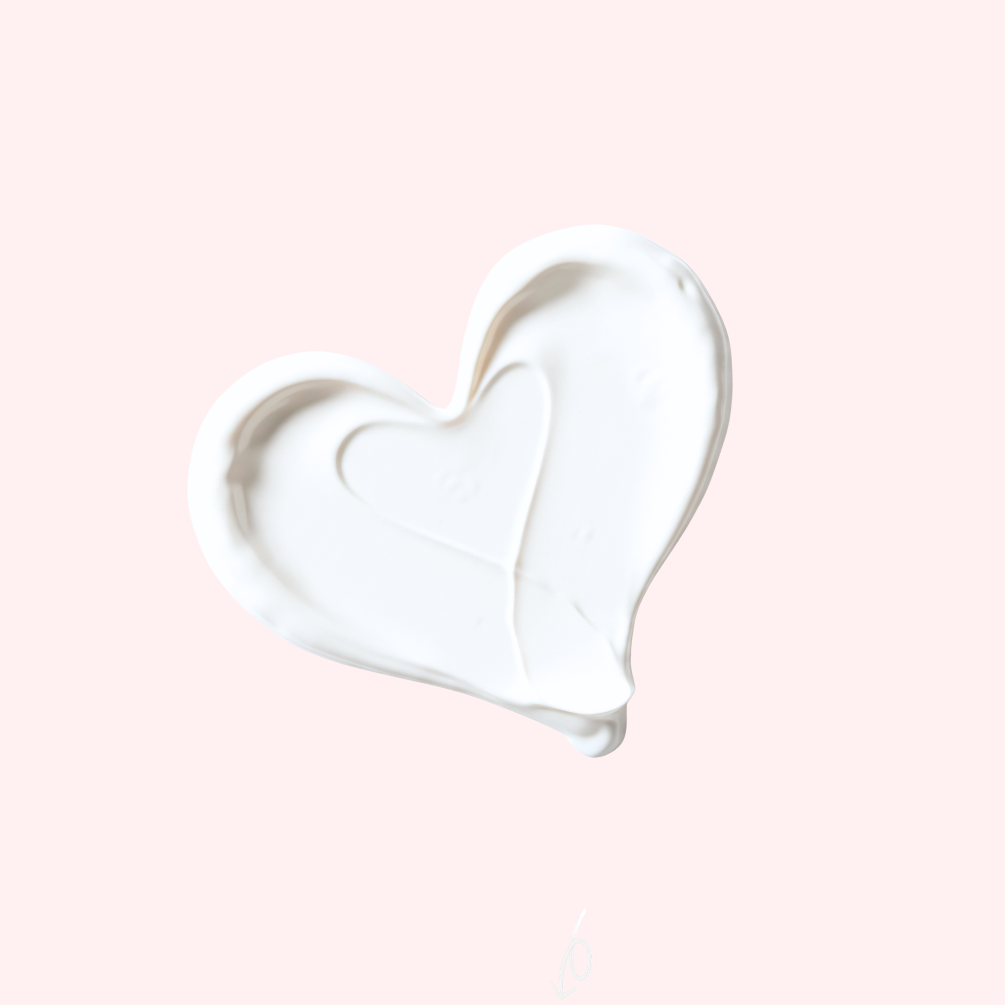 Heart-shaped cream smear on a light pink background