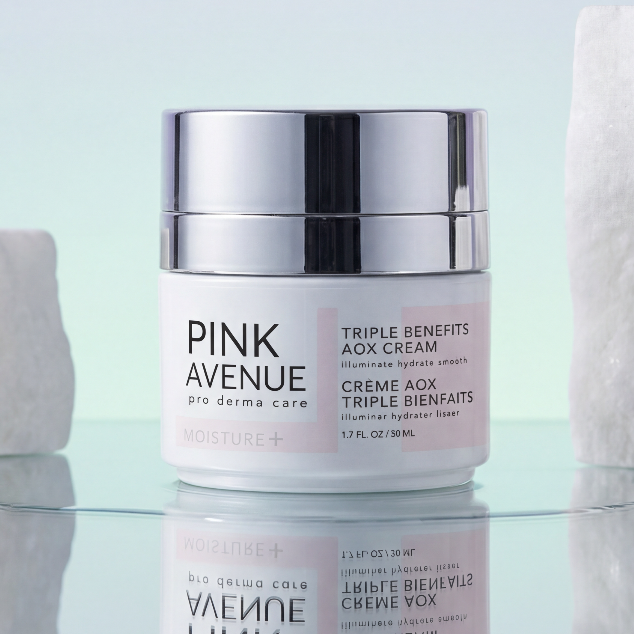 Pink Avenue cream jar on a reflective surface with a light blue background