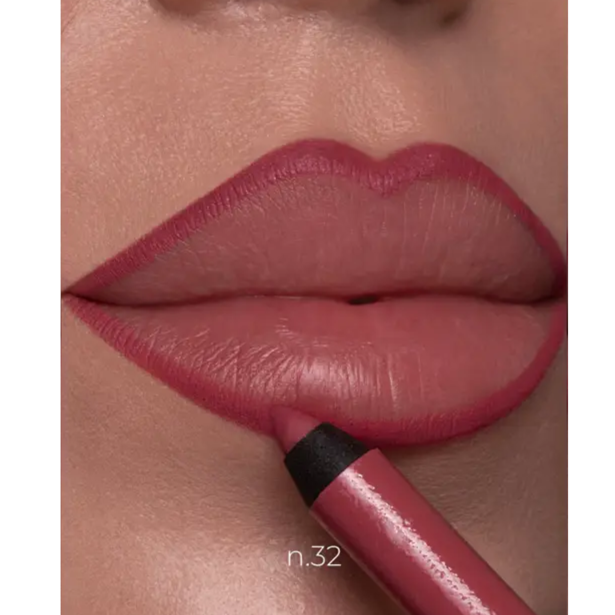 Close-up of a person's lips wearing a dusty rose pink lip color, with a matching lip crayon being applied near the lower lip. The text 'n.