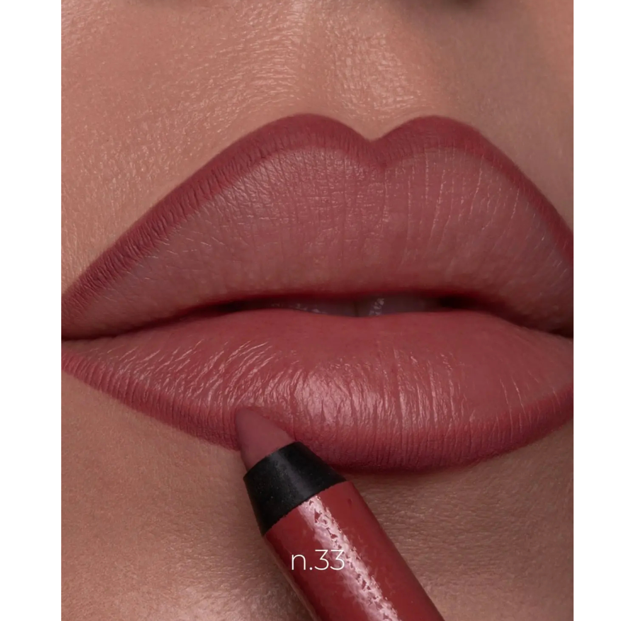 Close-up of lips wearing a dusty rose pink lip color, with a matching lip crayon being applied near the lower lip. The shade is labeled 'n.