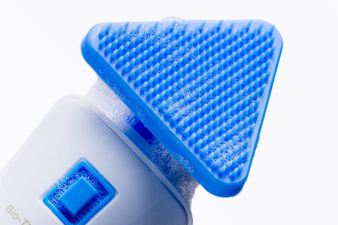 Blue scrubber with foam on a white background