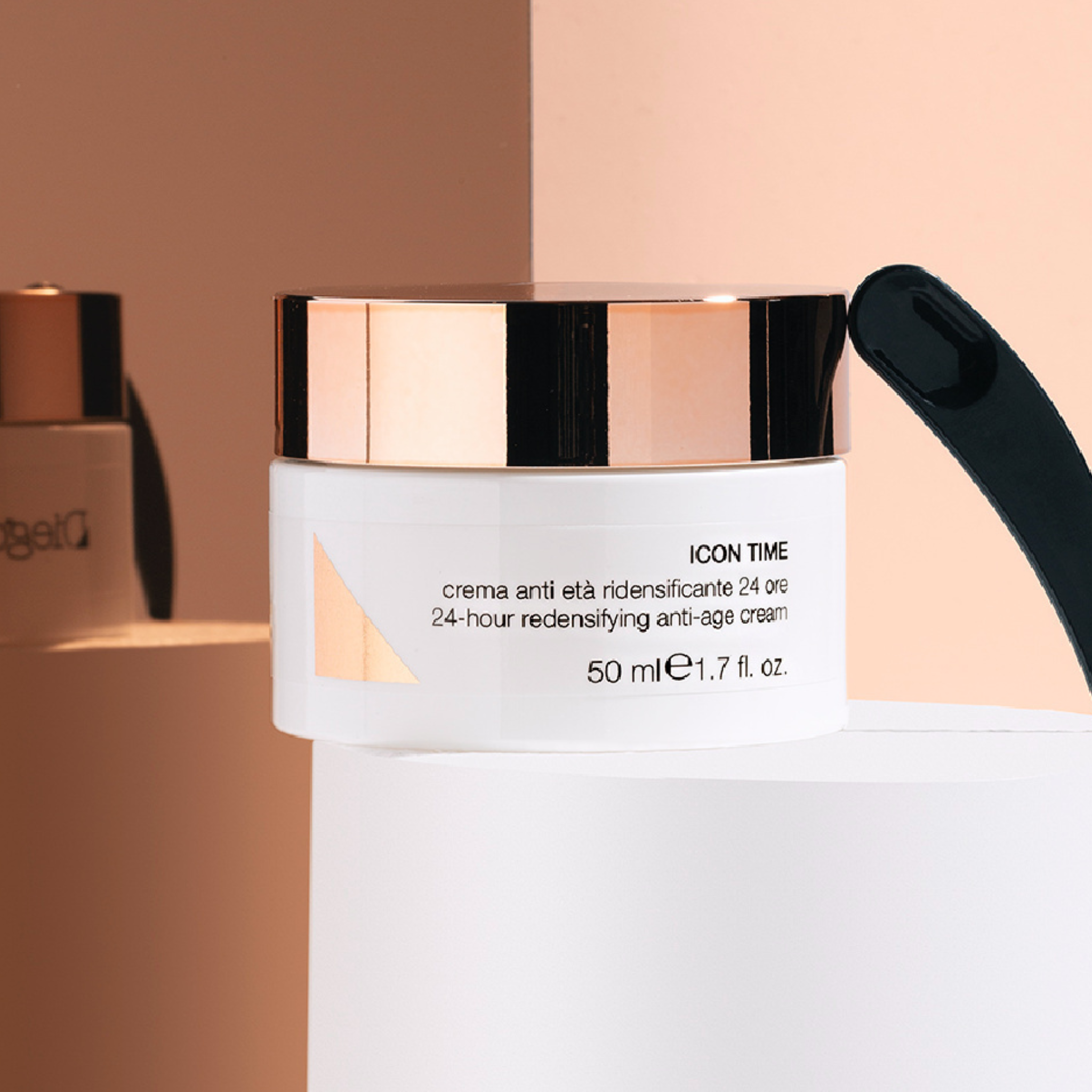 Cosmetic cream jar with rose gold lid on a beige background