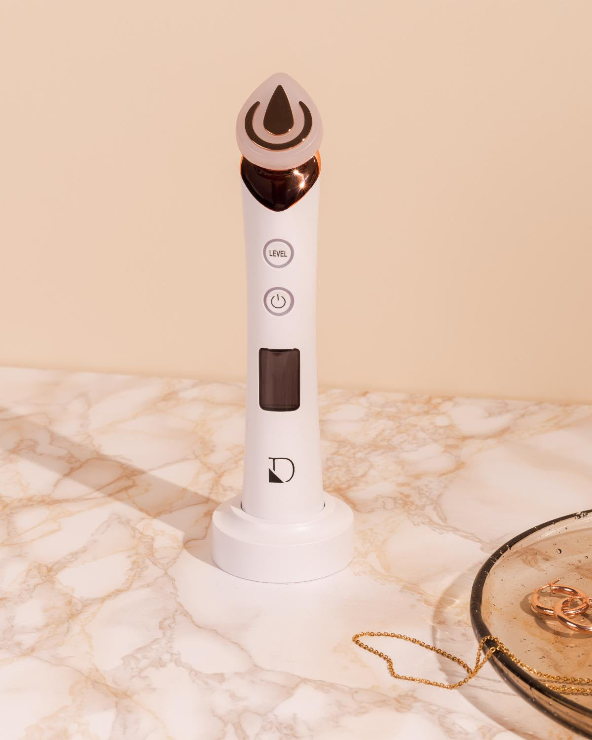 White electronic device with a droplet design on a marble surface