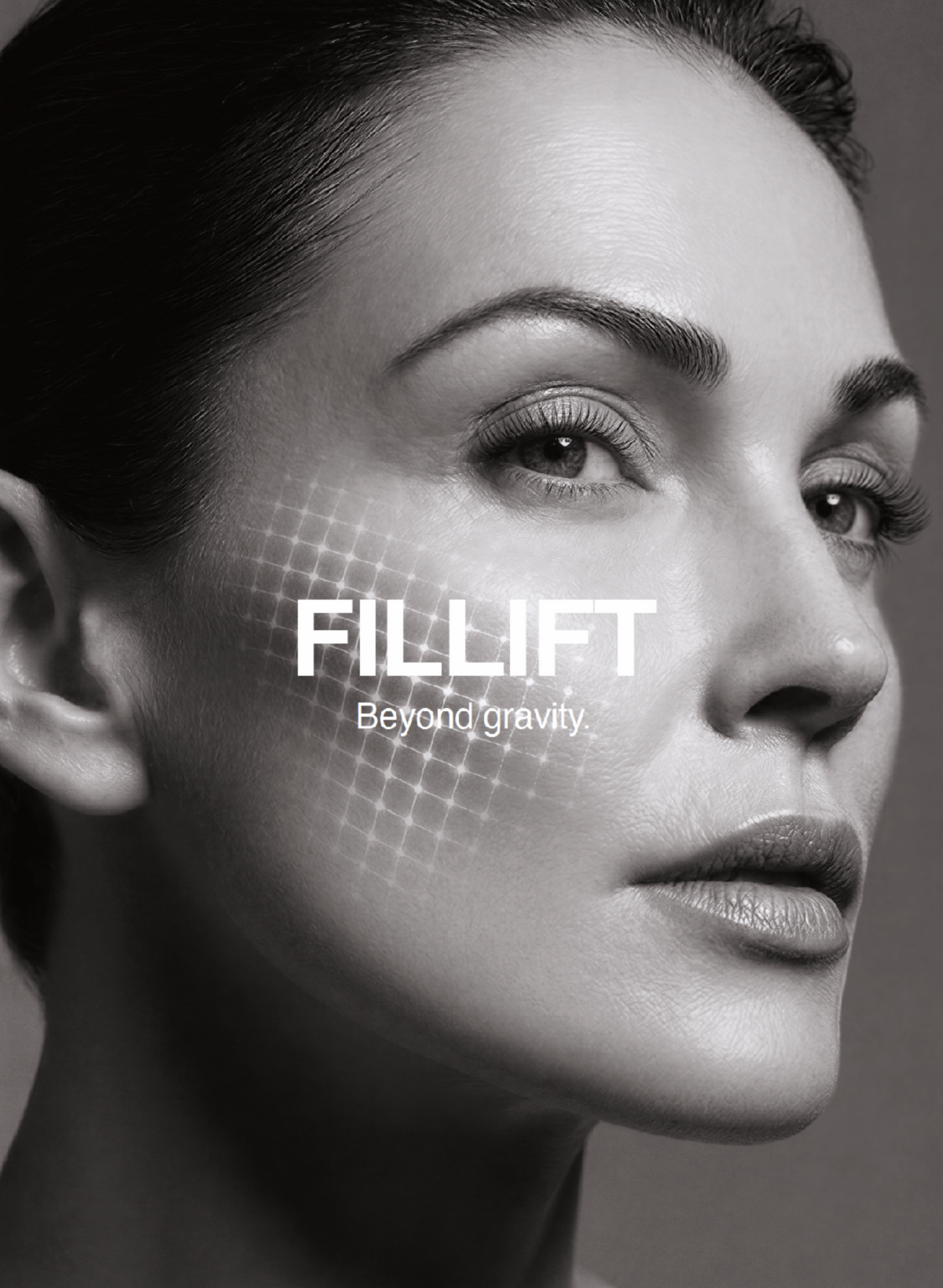 Black and white close-up portrait of a woman's face with the text 'FILLIFT Beyond gravity.' overlaid on her cheek, suggesting a cosmetic or skincare treatment.