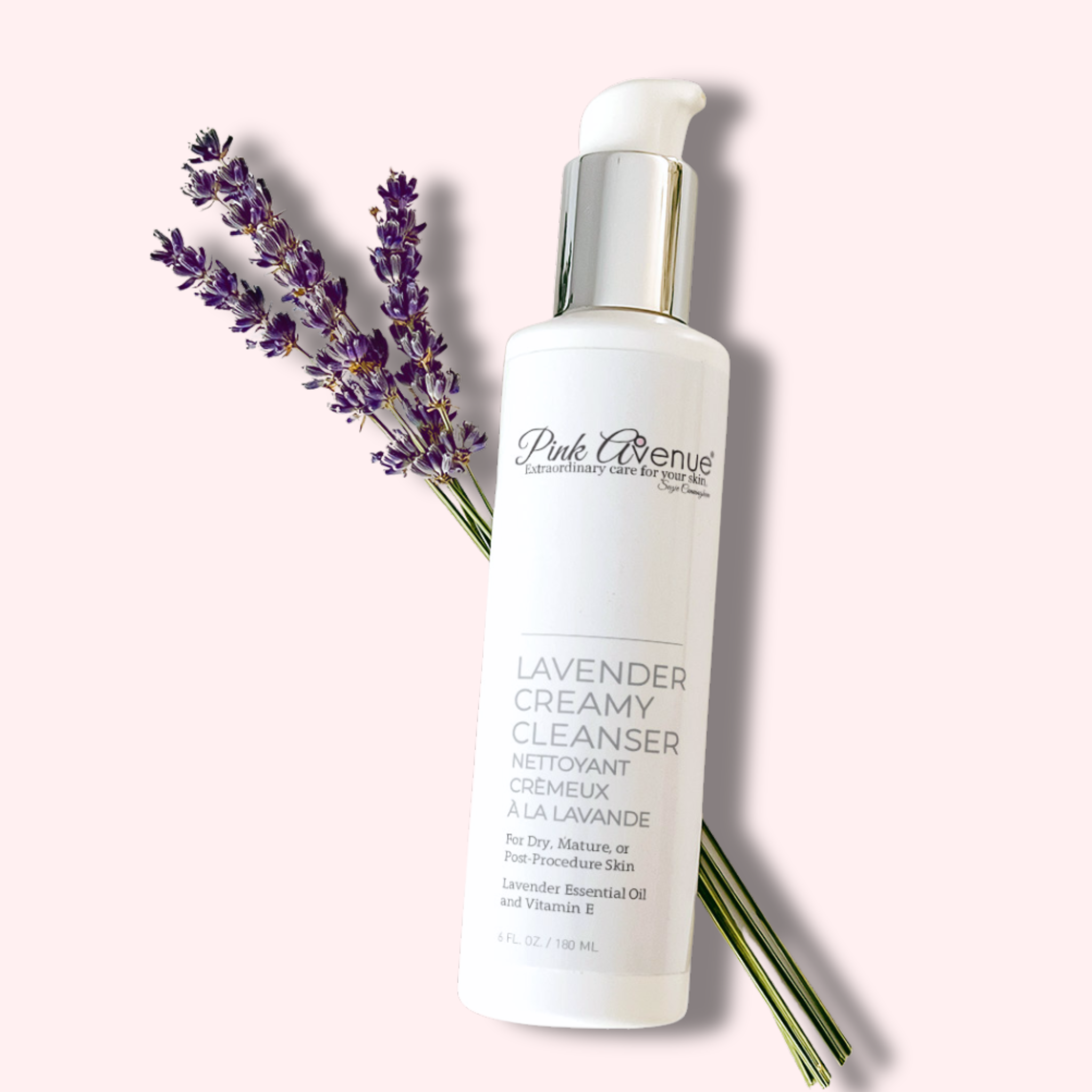 White bottle of Lavender Creamy Cleanser with lavender flowers on a light background