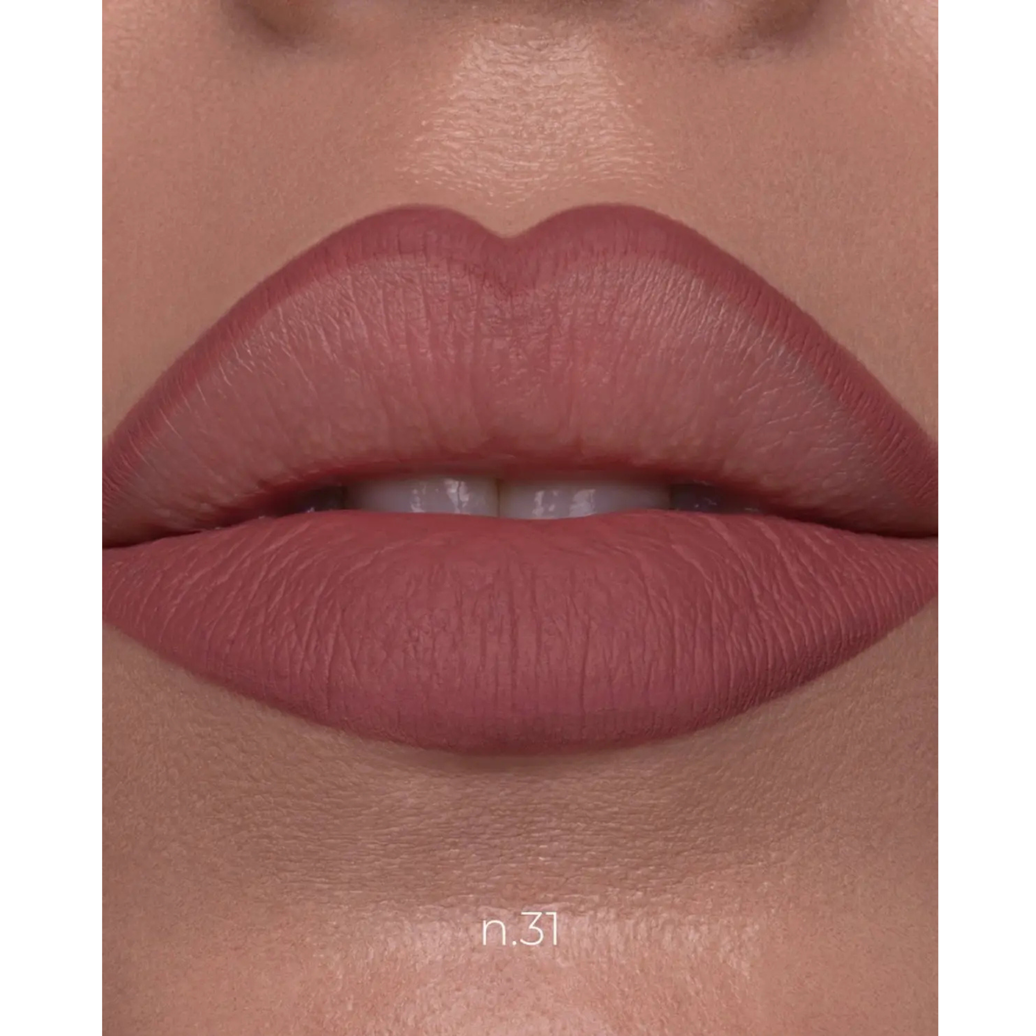 Close-up of a person's lips wearing a matte dusty rose lipstick shade, with the text 'n.31' printed near the bottom.